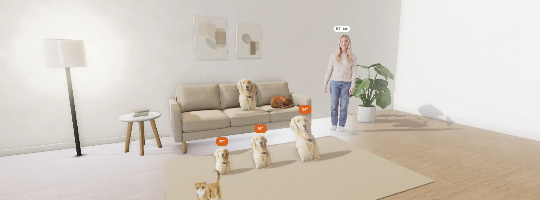 A living room with die-cut dog pillows from 12 inches up, a standing woman, a sofa and two cats, all at true scale